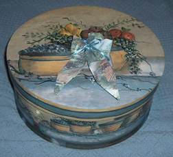 The lid on this particular hat box came with a label printed into the design, so I made a bow out of some matching leftover wallpaper and glued it over the label.