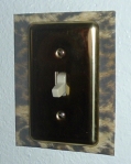 Once the screws are tightened, the switchplate securely holds the frame to the wall.