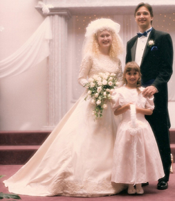 In her beautiful thrift-store wedding gown, Aimee stands proudly next to the groom and flower girl. Watch for future posts about other amazing cost-cutters at Aimee’s elegant yet Fiercely Frugal wedding.