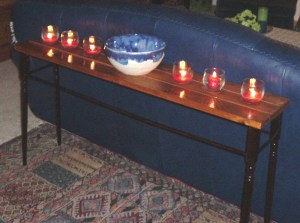Untreated cedar decking boards and old stair balusters were the main materials used to make the sofa table. I already had the doweling, L-brackets, screws, wood glue, and red-mahogany stain. The only extra expense was lighter stain for the tabletop.