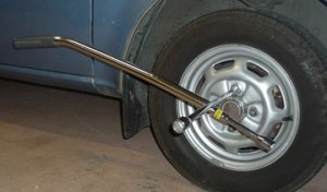 Slipping the vacuum handle over the lug wrench provides enough leverage to turn the lug nuts on my 1983 Dodge Colt.