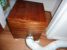 Exhaust hose enters wooden box