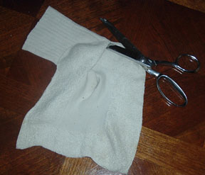 Slice the tube up the back, from the heel.